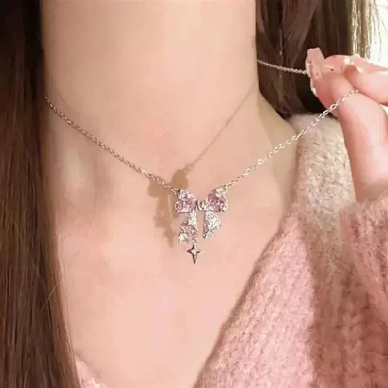 Pink crystal bow knot pendant necklace with rhinestone heart details. A sweet Y2K fairy-style accessory, perfect for girls and women.