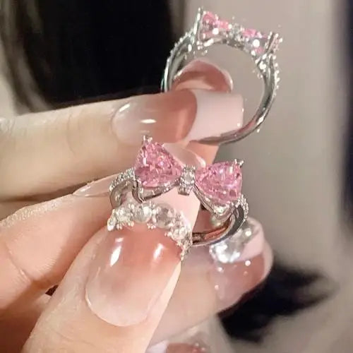 Pink crystal bow knot pendant necklace with rhinestone heart details. A sweet Y2K fairy-style accessory, perfect for girls and women.