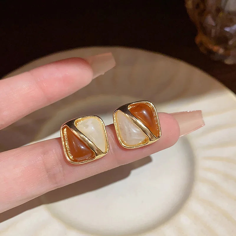 Korean-inspired geometric pearl ear clips with contrast colors. Retro style, no ear piercing required.