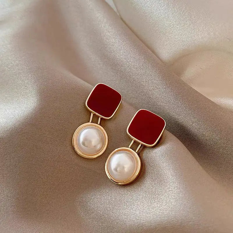 Korean-inspired geometric pearl ear clips with contrast colors. Retro style, no ear piercing required.