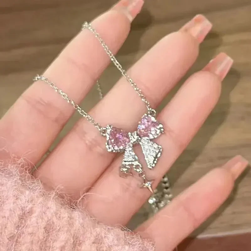 Pink crystal bow knot pendant necklace with rhinestone heart details. A sweet Y2K fairy-style accessory, perfect for girls and women.