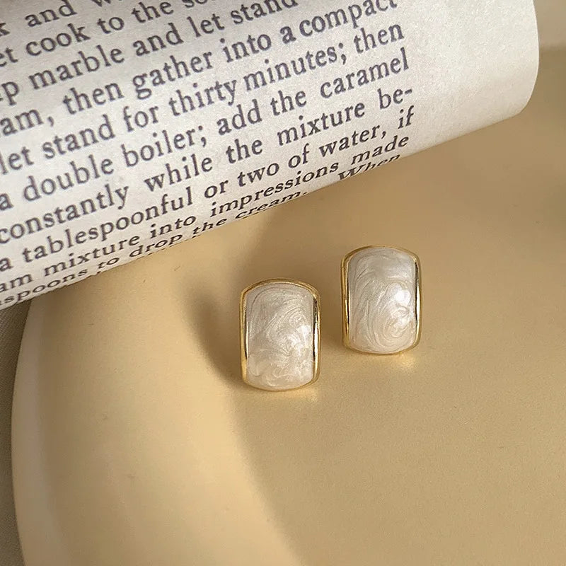 Korean-inspired geometric pearl ear clips with contrast colors. Retro style, no ear piercing required.