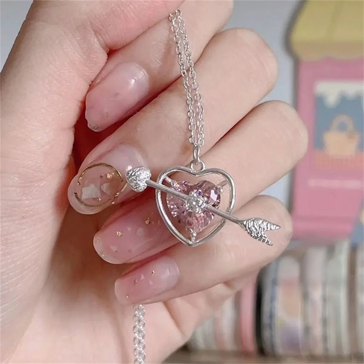 Pink crystal bow knot pendant necklace with rhinestone heart details. A sweet Y2K fairy-style accessory, perfect for girls and women.
